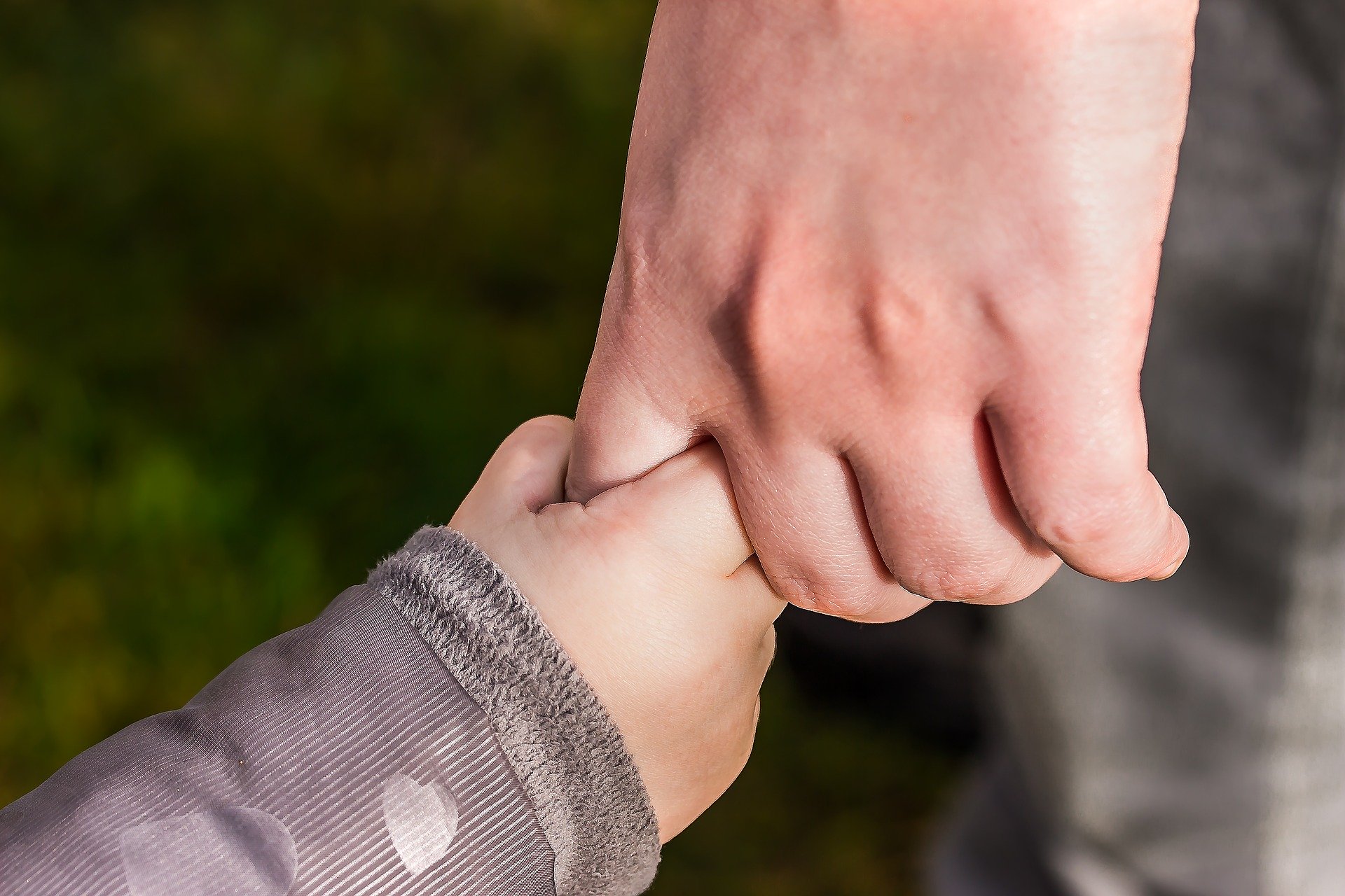 Child's hand in his Fathers