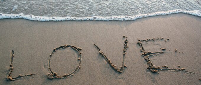 brown sand love text on seashore