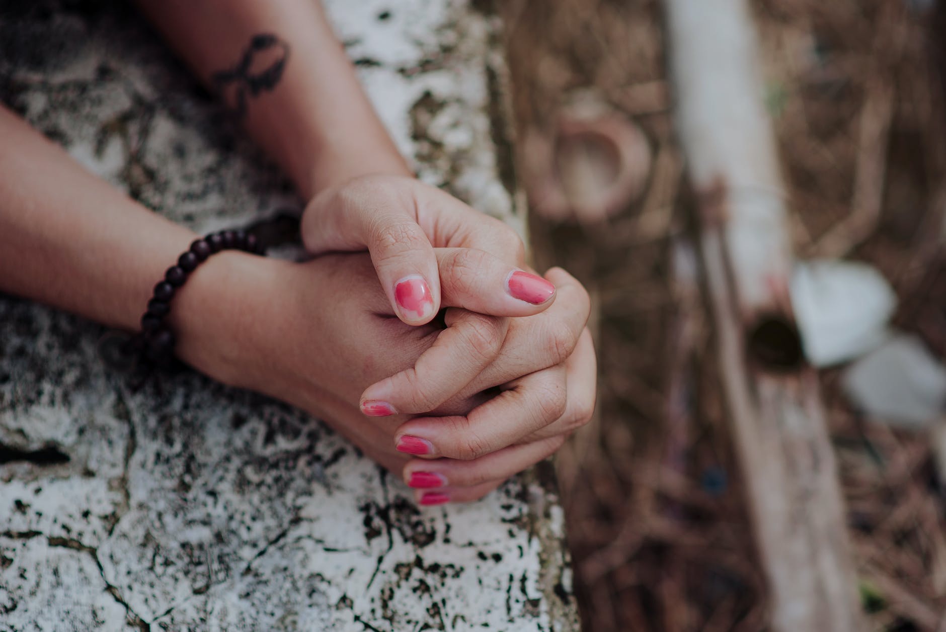 depth of field photography of human hands on white surface Pray