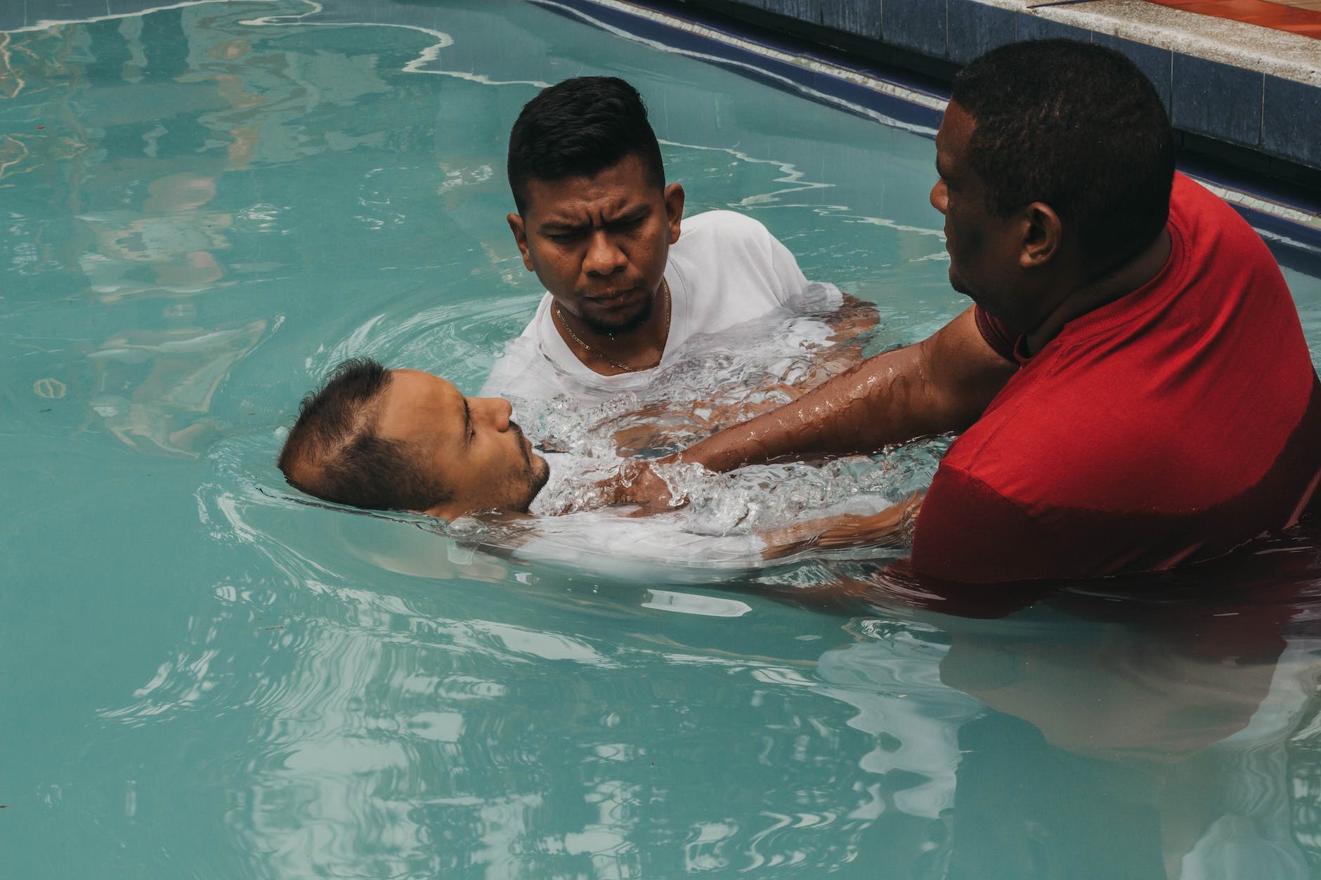 a man doing christian baptism on the water