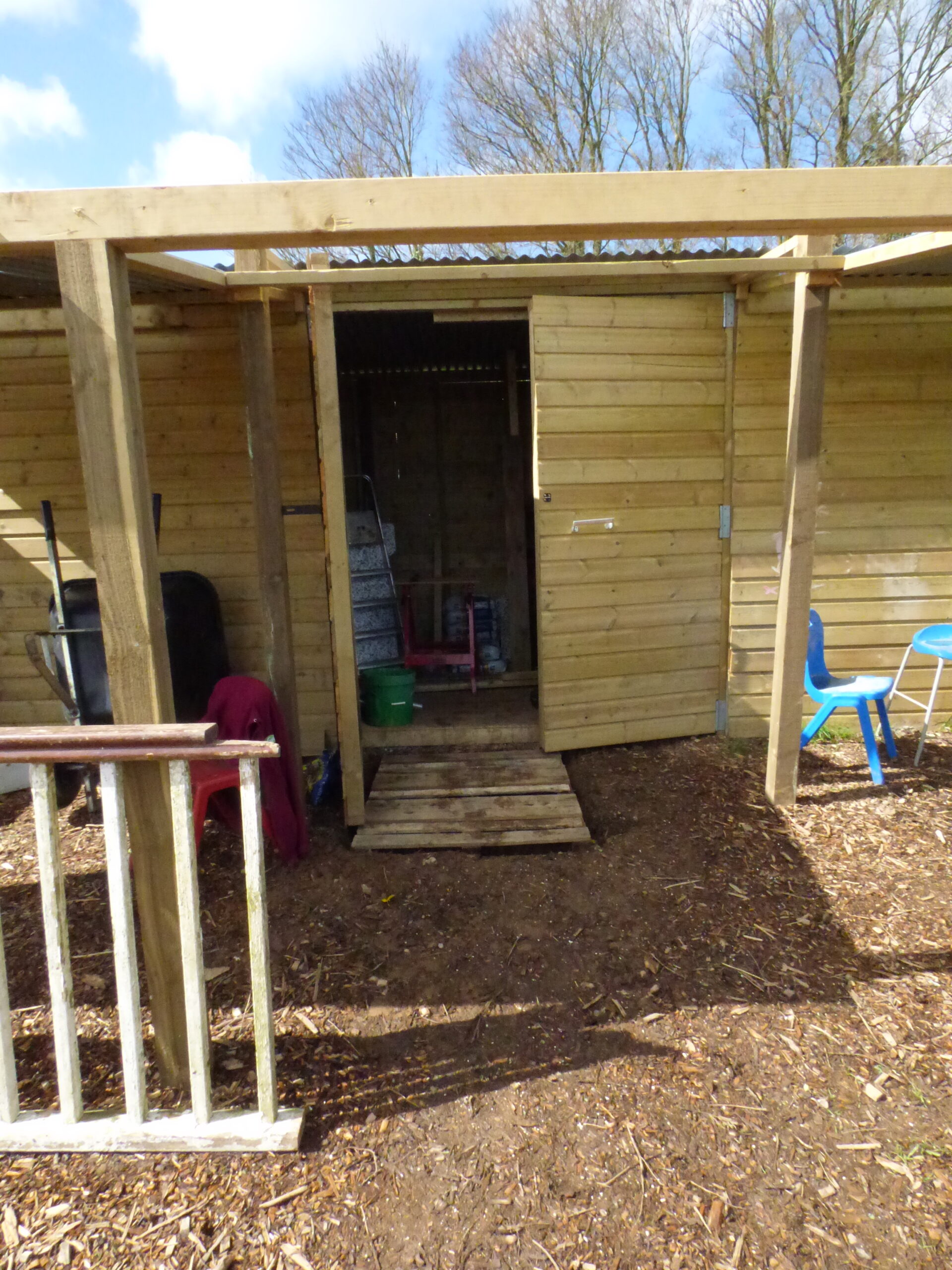 Barn door using a pallet to stop the mud