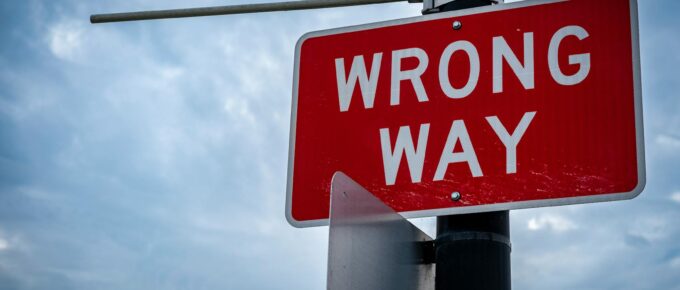 road sign under clouds