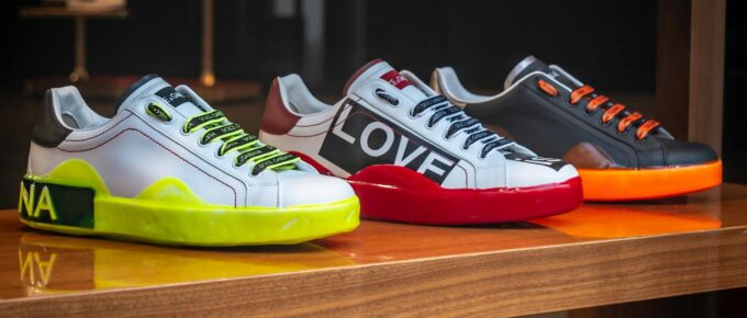 three unpaired multicolored leather sneakers on display