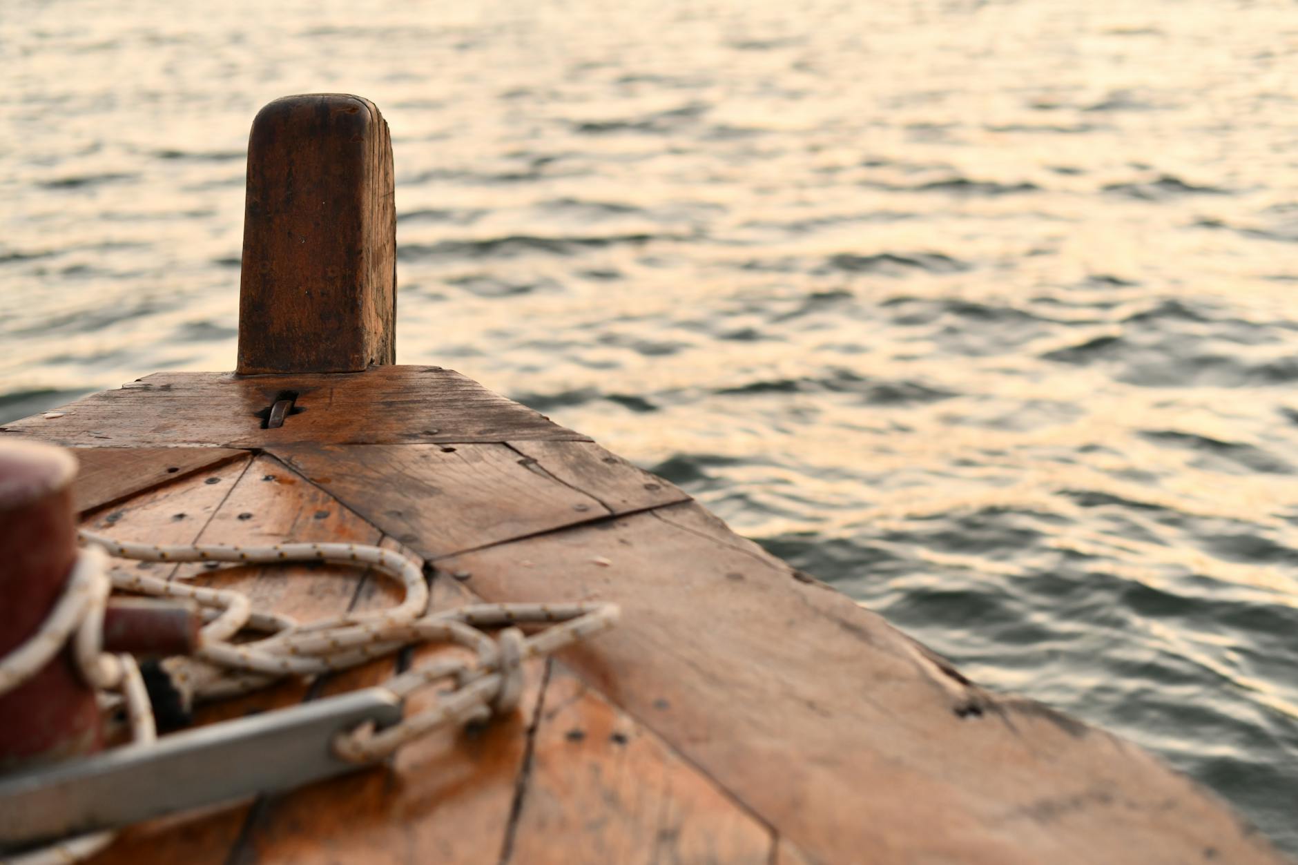 a wooden boat with a rope tied to it