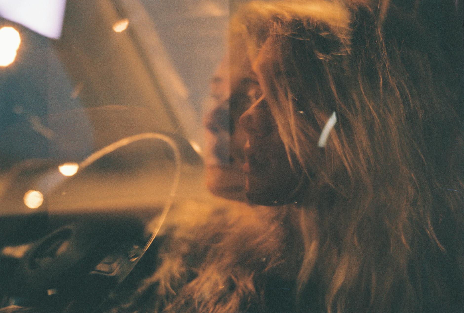 reflection of a woman on a car window