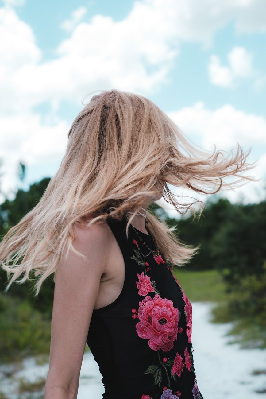 woman in a floral top flipping her hair