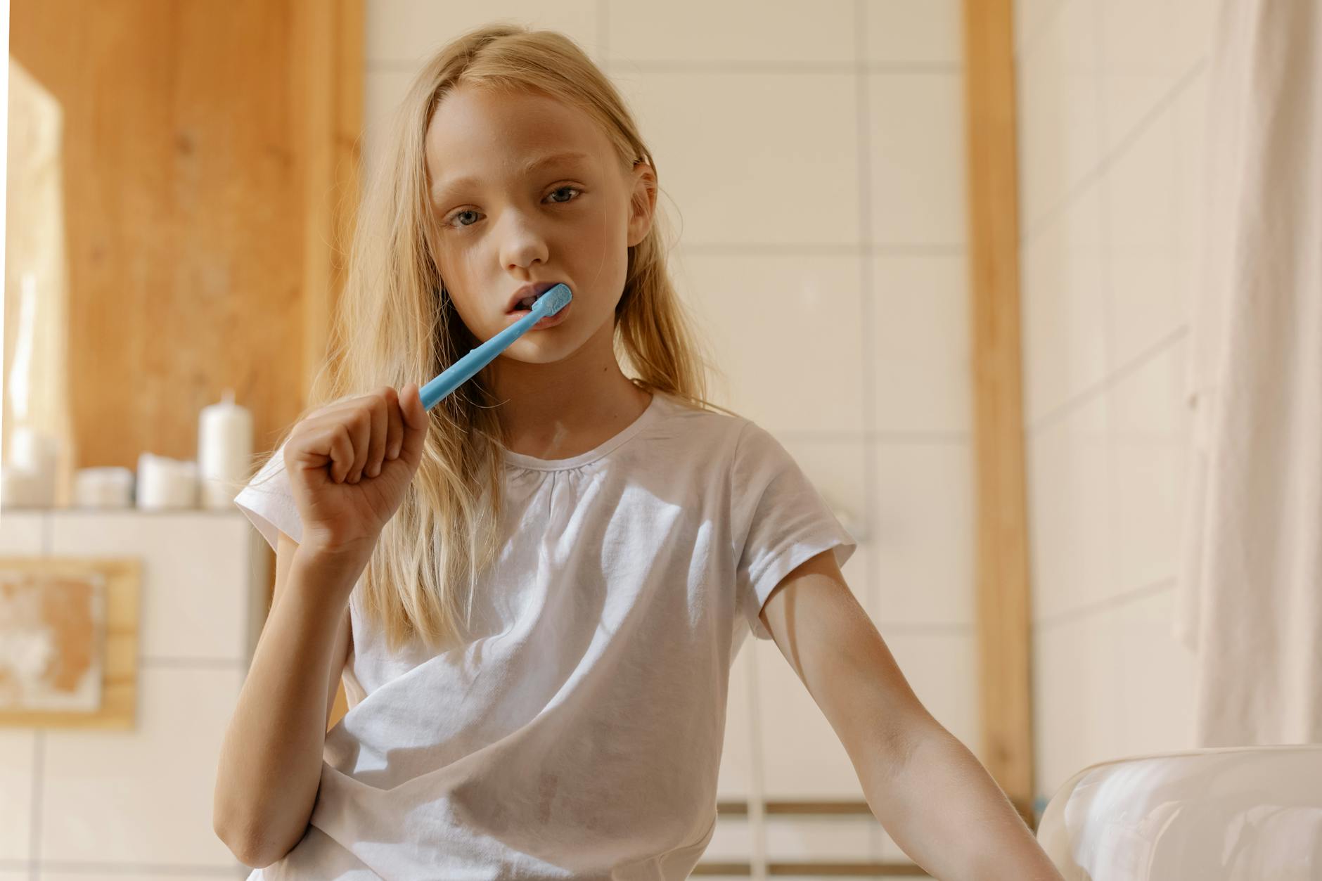 a girl brushing her teeth