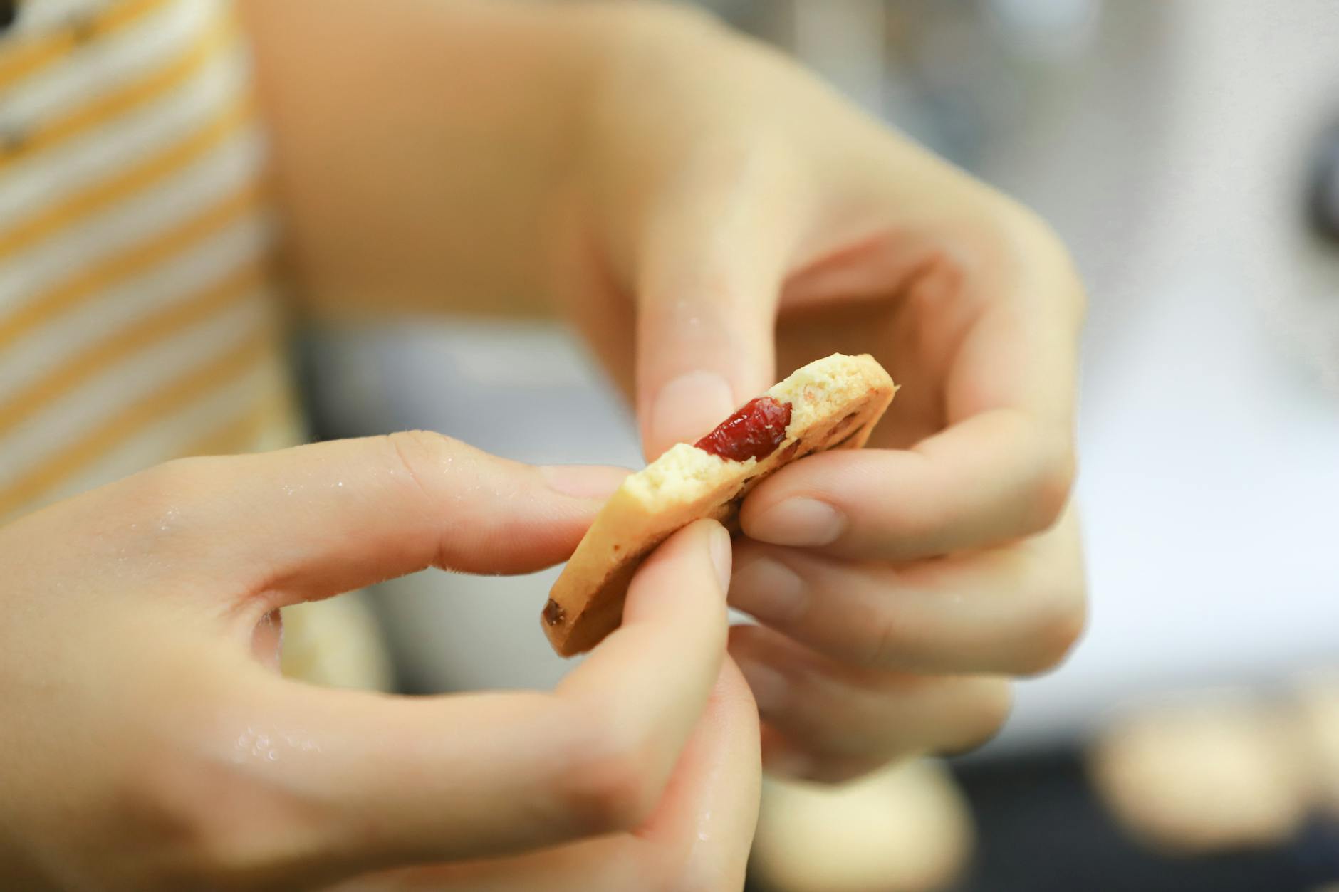 person holding biscuit with both hands