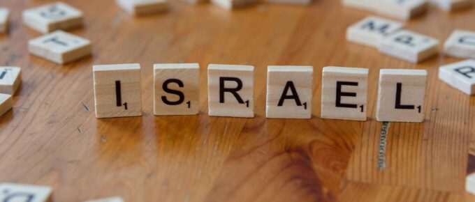 scrabble tiles spelling israel on a table