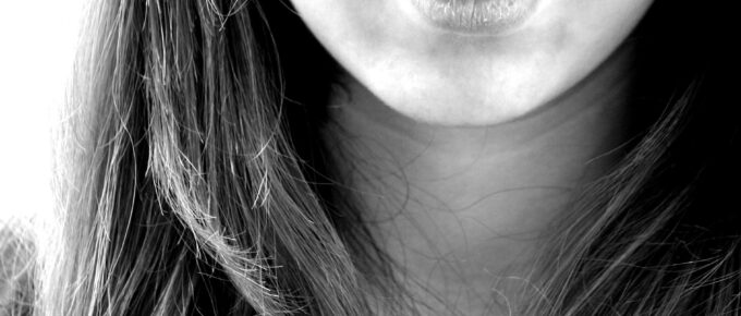 woman smiling in grayscale photography